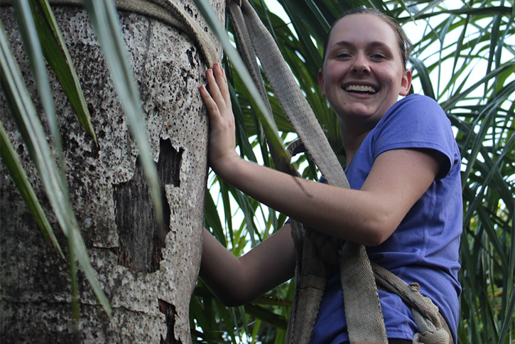 Smiling student in a tree